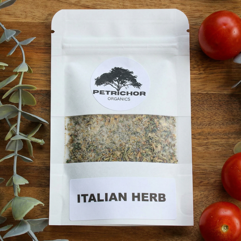 Petrichor Organics Italian Herb Seasoning Packet on a wooden surface with tomatoes and herbs.
