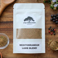 Petrichor Organics Mediterranean Lamb Blend Organic Seasoning Packet on a wooden surface with herbs and spices.