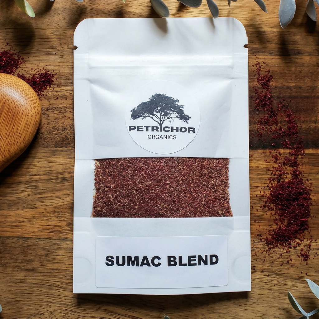 Petrichor Organics Organic Sumac Blend package on a wooden surface with eucalyptus leaves.