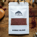 Petrichor Organics Organic Sumac Blend package on a wooden surface with eucalyptus leaves.